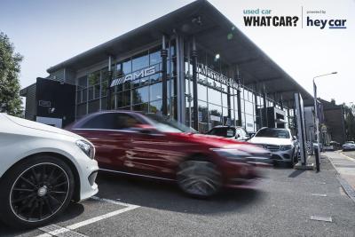 Mercedes driving off dealership forecourt