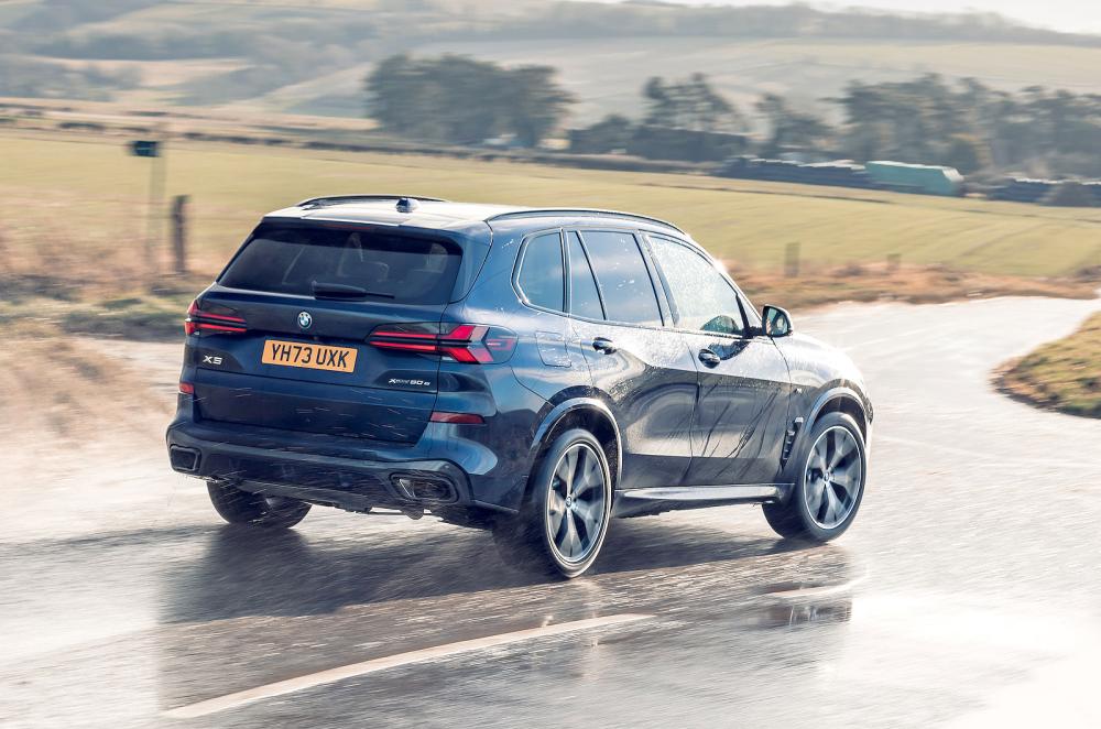 Blue BMW X5 rear right driving