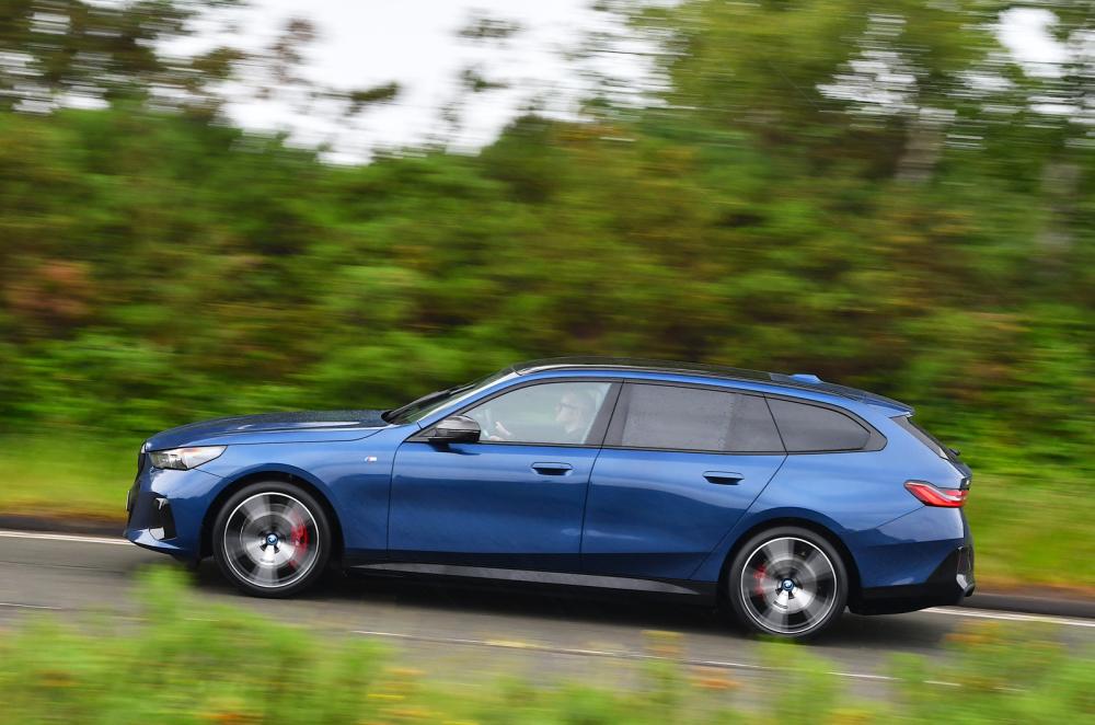 BMW i5 Touring side driving