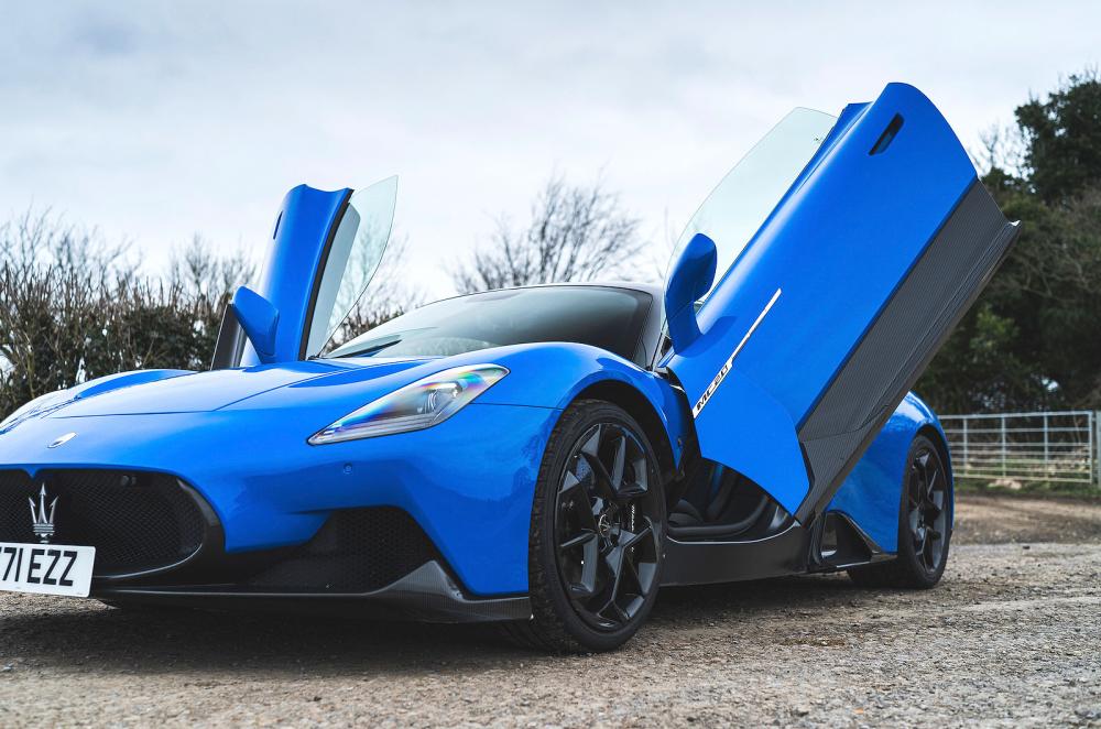 Blue Maserati MC20 front left static doors open