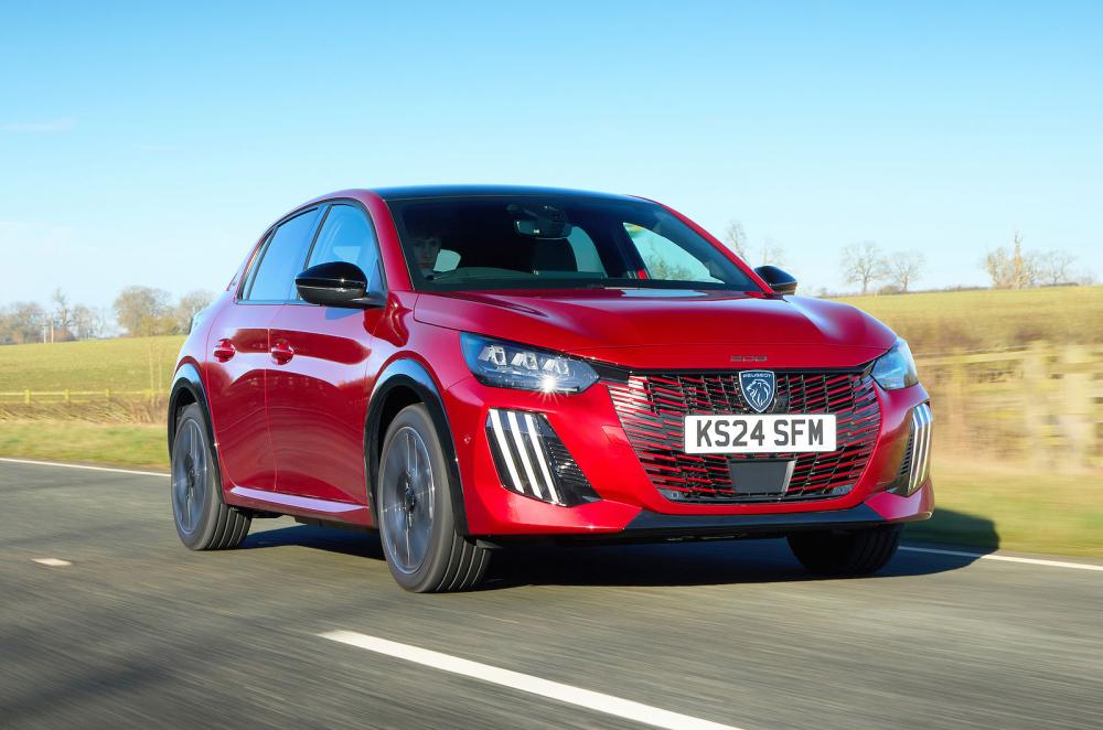 Red Peugeot 208 front right driving