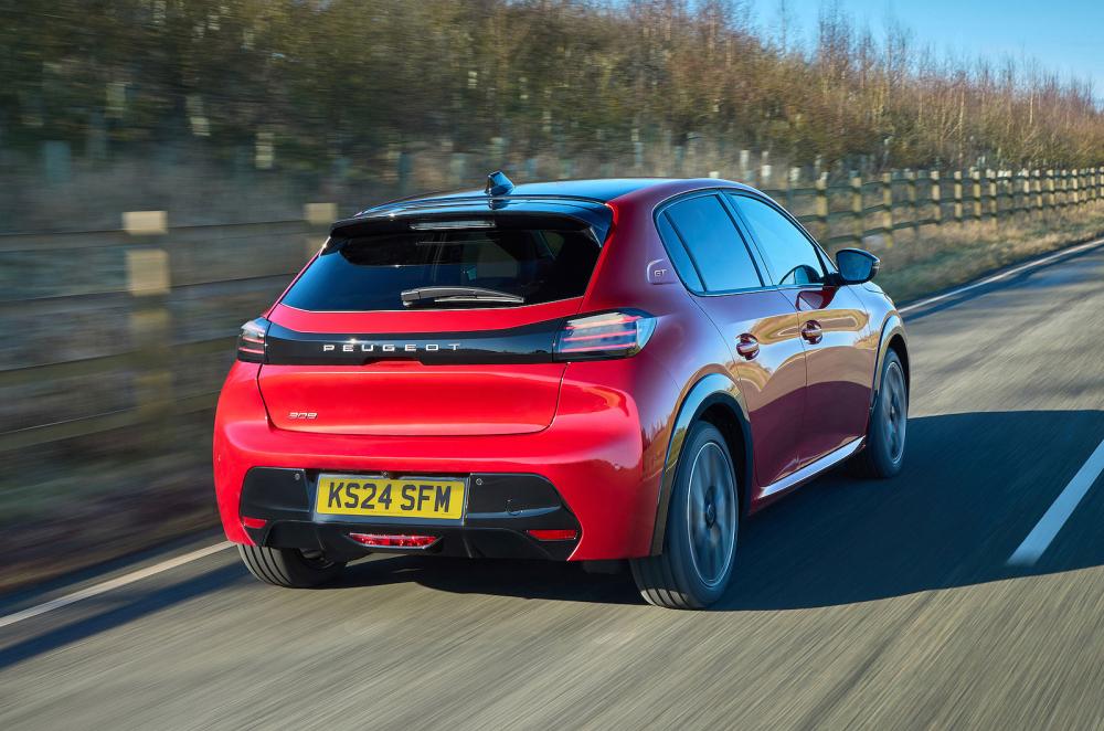 Red Peugeot 208 rear right driving