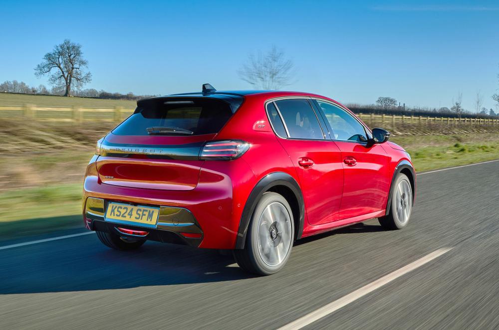 Red Peugeot 208 rear right driving