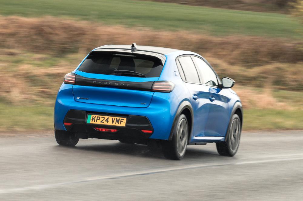 Blue Peugeot e-208 rear right driving