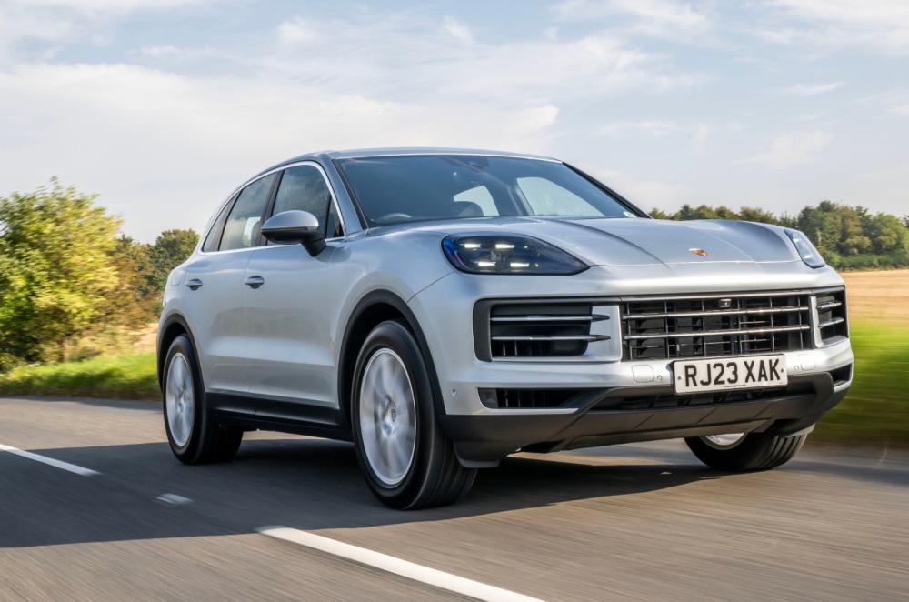 Silver Porsche Cayenne front driving