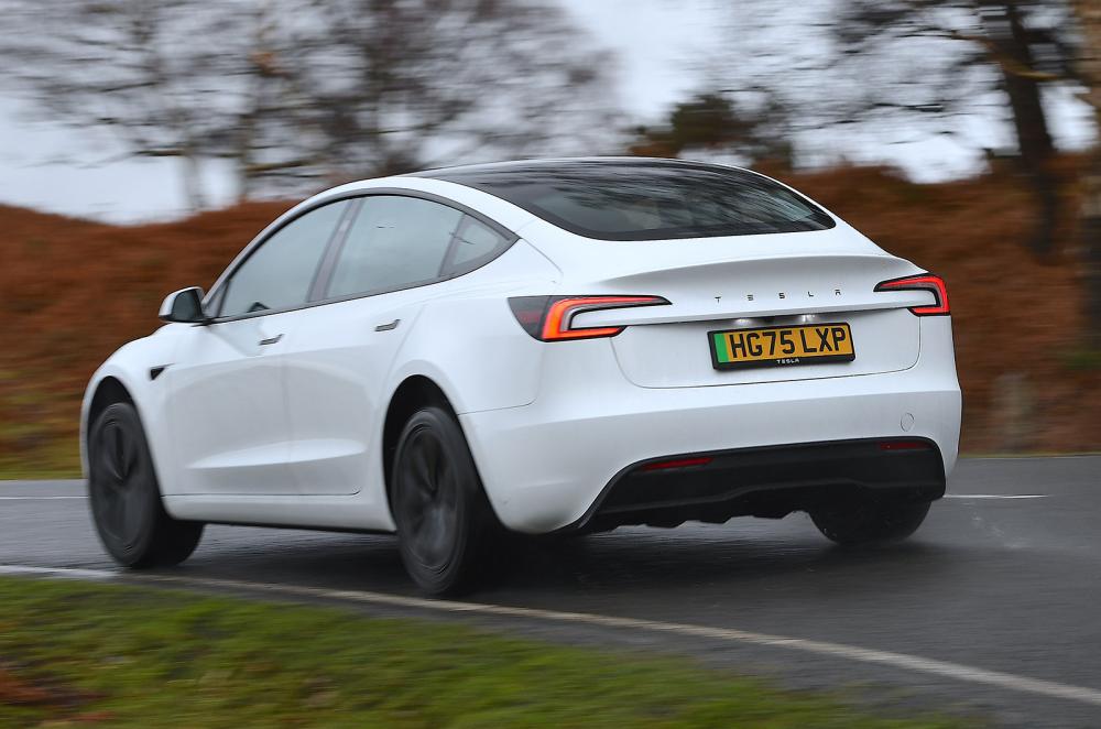 Tesla Model 3 driving rear left