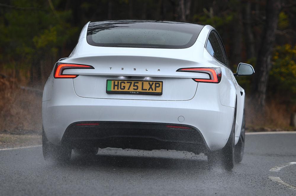 Tesla Model 3 driving rear