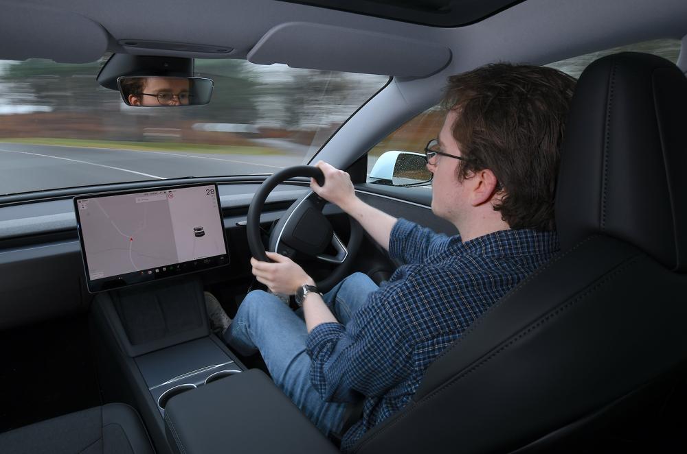 Oliver Young driving the Tesla Model 3