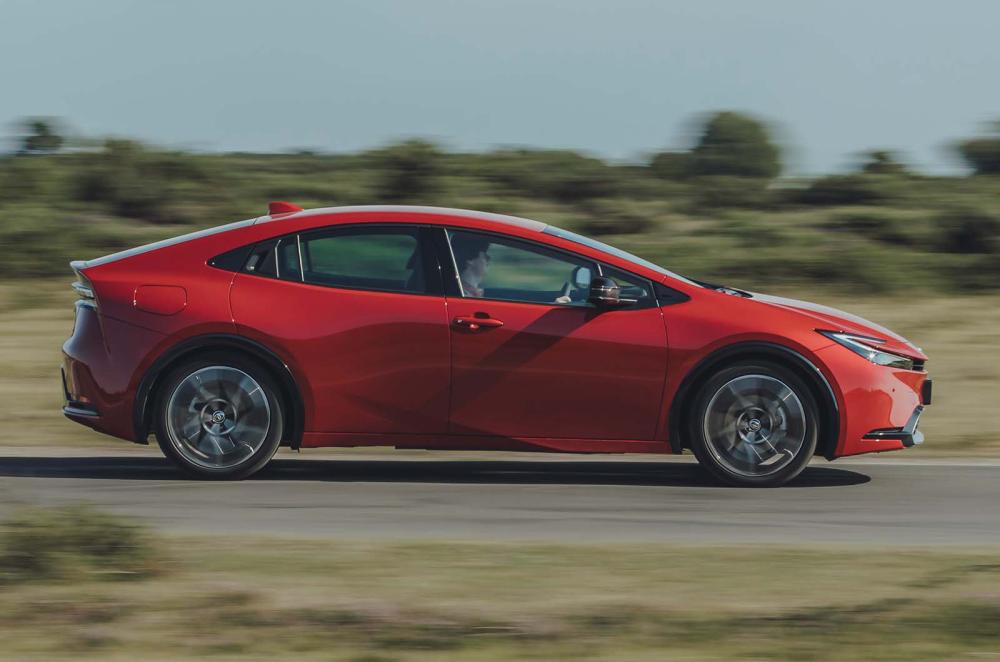 Toyota Prius side driving red