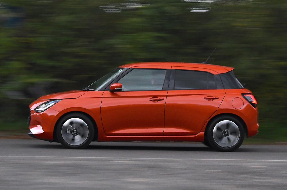 Used Suzuki Swift 2024-present panning shot orange
