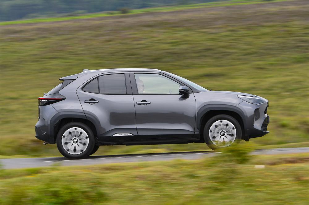 Used Toyota Yaris Cross 2021-present side driving grey