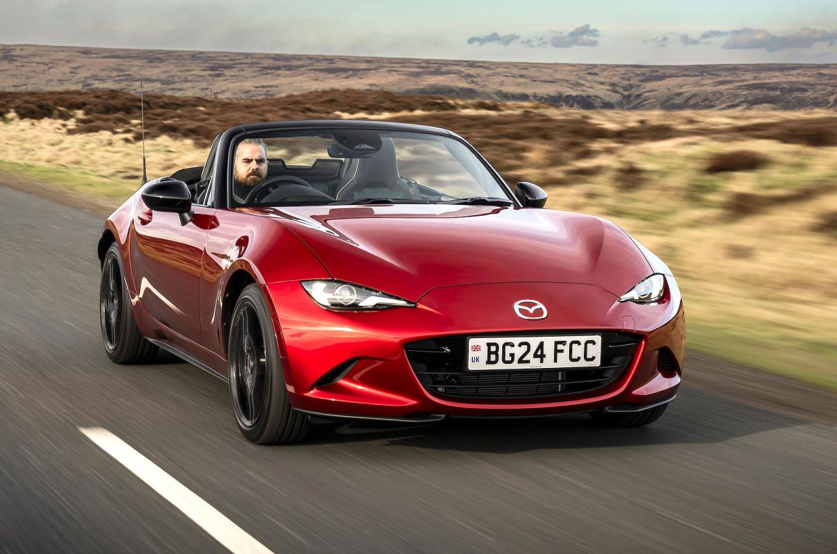 Red Mazda MX-5 Roadster front right driving