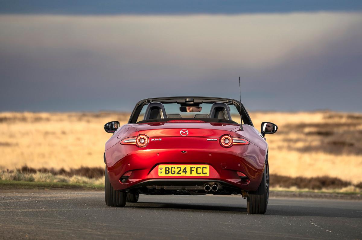 Red Mazda MX-5 Roadster rear driving