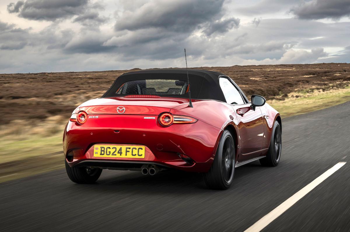 Red Mazda MX-5 Roadster rear right driving