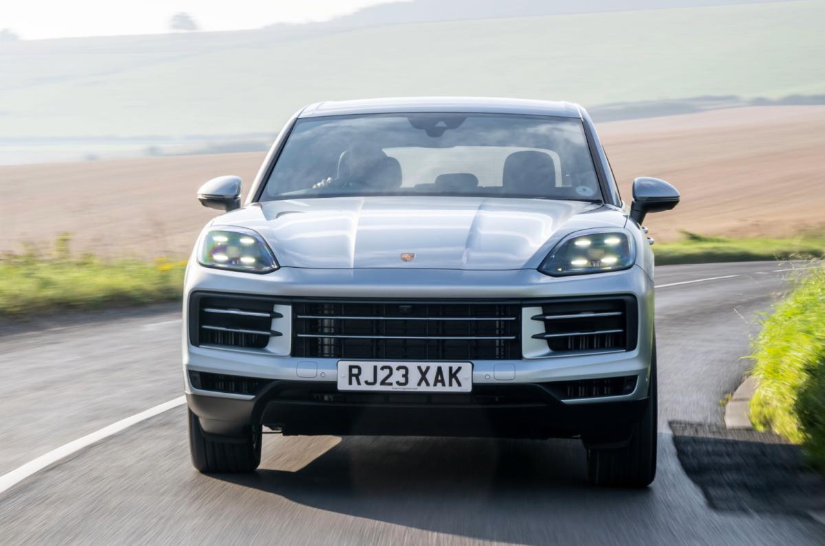 Silver Porsche Cayenne front driving