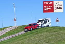 Skoda Elroq descending steep slope while towing caravan