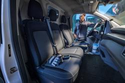 An interior shot of the Volkswagen Transporter showing the seats and cup holder