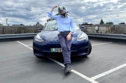 James Tute with crash helmet and Tesla Model 3 Performance