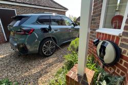 BMW iX1 plugged into home wallbox