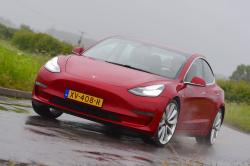 Red Tesla Model 3 front cornering
