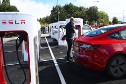 Tesla Model 3 plugged in to Supercharger