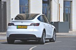 White Tesla Model Y rear cornering